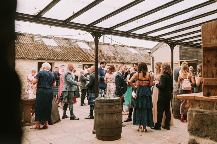 under cover courtyard bar at rustic barn wedding venue Cardney Steading